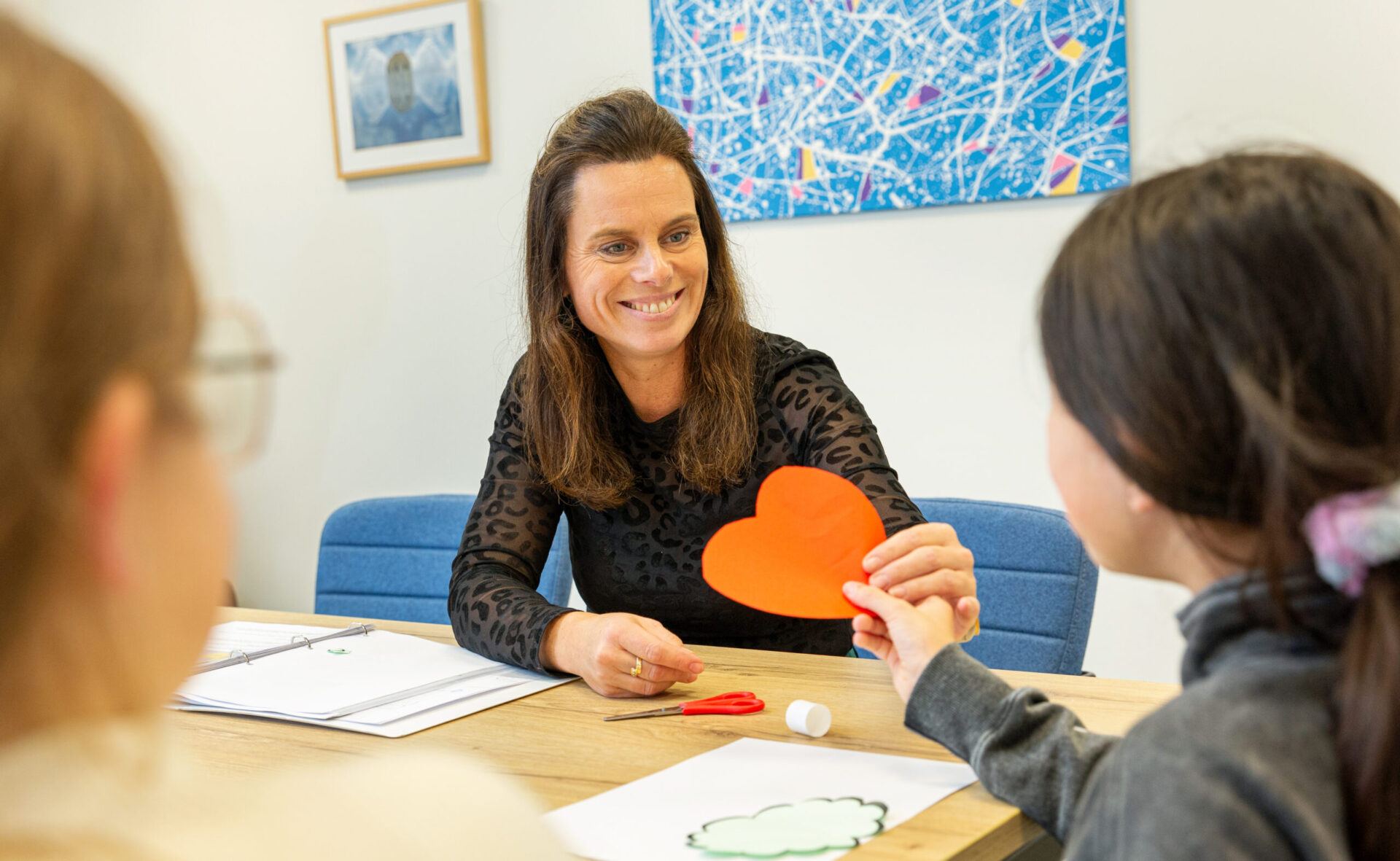 Medewerker met kind aan het knutselen